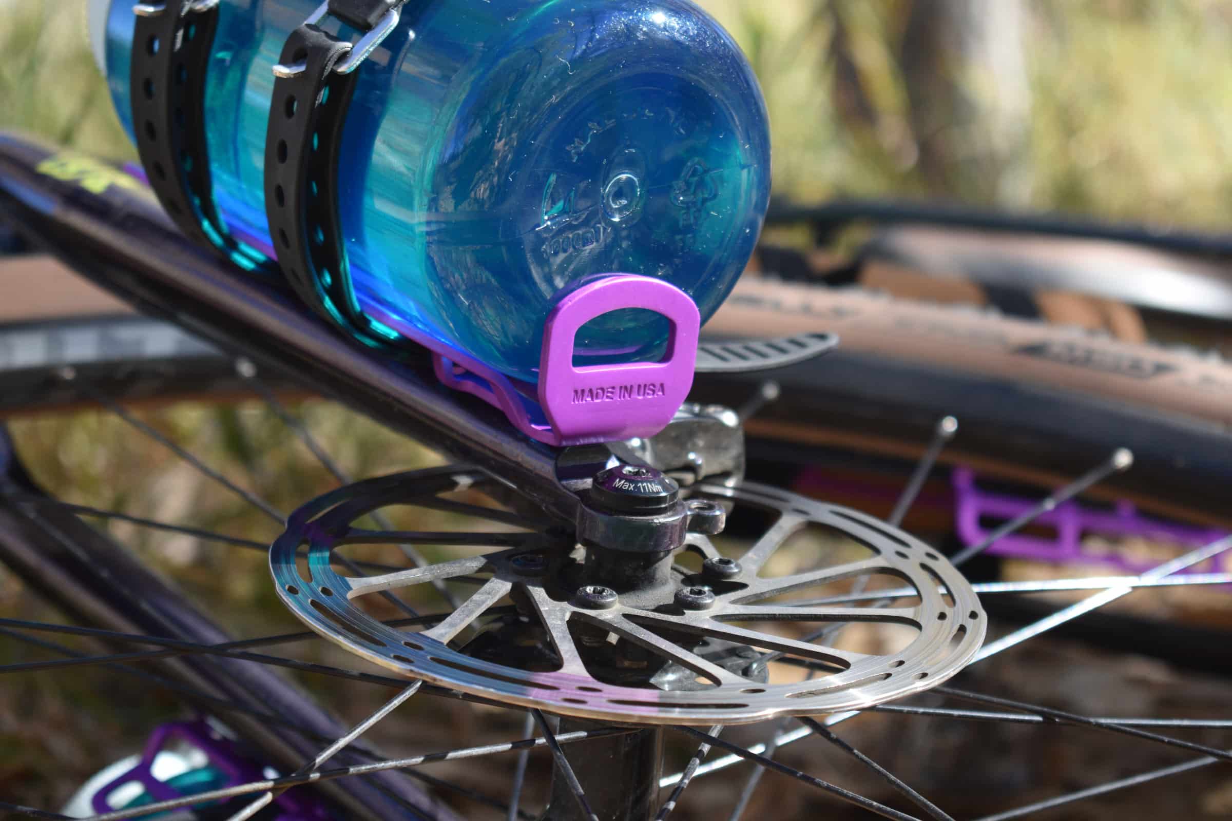 CargoMount holding Naglene bottle on bike fork displaying MADE IN USA